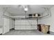 Spacious garage with overhead storage racks and an automatic door at 7435 Jamestown Dr, Alpharetta, GA 30005
