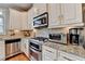 Gourmet kitchen featuring stainless steel appliances and granite countertops at 7435 Jamestown Dr, Alpharetta, GA 30005