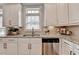 Close-up of kitchen with stainless dishwasher, granite counters, and white cabinets at 7435 Jamestown Dr, Alpharetta, GA 30005