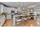 Modern kitchen with white cabinetry, granite countertops, stainless steel appliances, and a spacious island with seating at 7435 Jamestown Dr, Alpharetta, GA 30005