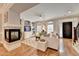 Bright living room with a cozy fireplace, hardwood floors, and elegant furniture at 7435 Jamestown Dr, Alpharetta, GA 30005