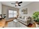 Cozy living room with hardwood floors, a ceiling fan, and a comfortable sofa at 7435 Jamestown Dr, Alpharetta, GA 30005