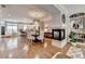 Open-concept living and dining area featuring hardwood floors, a cozy fireplace, and a seamless flow to the modern kitchen at 7435 Jamestown Dr, Alpharetta, GA 30005