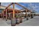 Outdoor patio with barrels and wooden beams providing shaded seating at 7435 Jamestown Dr, Alpharetta, GA 30005