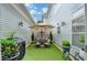 Private outdoor patio with artificial turf, seating, and garden decor at 7435 Jamestown Dr, Alpharetta, GA 30005