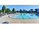 Outdoor pool surrounded by lounge chairs, tables, and lush greenery at 7435 Jamestown Dr, Alpharetta, GA 30005