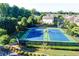 Tennis courts surrounded by lush greenery in a residential community at 7435 Jamestown Dr, Alpharetta, GA 30005