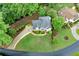 A beautiful home with a landscaped yard, circular driveway, and mature trees provides privacy at 125 Forrest Lake Rd, Johns Creek, GA 30022