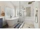 Bright bathroom featuring a soaking tub, and a glass enclosed shower with tasteful tile accents at 125 Forrest Lake Rd, Johns Creek, GA 30022