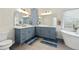 Stylish bathroom featuring dual sinks, a soaking tub, and modern fixtures at 125 Forrest Lake Rd, Johns Creek, GA 30022