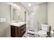 Neutral toned bathroom with a wooden vanity, mirror, lighting fixture and a walk-in shower at 125 Forrest Lake Rd, Johns Creek, GA 30022