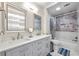 Modern bathroom with double sinks, quartz countertops, and tiled shower/tub at 125 Forrest Lake Rd, Johns Creek, GA 30022