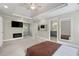 Open bedroom with a fireplace, television, ceiling fan and access to an en-suite bathroom at 125 Forrest Lake Rd, Johns Creek, GA 30022