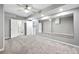 Bedroom featuring plush carpet, ceiling fan, mirror accent wall, and an ensuite bathroom at 125 Forrest Lake Rd, Johns Creek, GA 30022