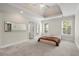 A spacious bedroom with a trey ceiling, neutral walls, large windows and wall mirrors at 125 Forrest Lake Rd, Johns Creek, GA 30022