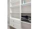 Walk-in closet featuring shelving, cabinets, and drawers for optimal storage at 125 Forrest Lake Rd, Johns Creek, GA 30022