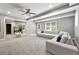 Open concept living room featuring high ceilings, large windows, carpeted floors and a modern sectional at 125 Forrest Lake Rd, Johns Creek, GA 30022