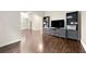 A bright living room features dark hardwood floors and built-in shelving for storage at 125 Forrest Lake Rd, Johns Creek, GA 30022