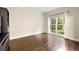 Bright room with hardwood floors, neutral walls, and a large window overlooking the exterior at 125 Forrest Lake Rd, Johns Creek, GA 30022