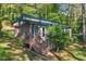 Charming exterior view of home with a cozy front porch and natural, wooded surroundings at 135 Marina Ct, Canton, GA 30114