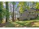 Back of house with wooded area, lake view, and air conditioning at 135 Marina Ct, Canton, GA 30114