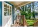Close up of the charming front porch with a view of the lake at 135 Marina Ct, Canton, GA 30114