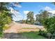 View of parking lot with mature trees, landscaping, and clear signage at 135 Marina Ct, Canton, GA 30114