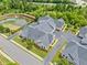 Aerial view of multiple residences showcases lush landscaping, a serene pond, and well-maintained community grounds at 306 Cherokee Station Cir, Woodstock, GA 30188