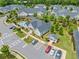 Aerial view of a community clubhouse, swimming pool, and accessible parking surrounded by lush greenery and residences at 306 Cherokee Station Cir, Woodstock, GA 30188