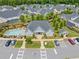 An aerial view showcases a community clubhouse, swimming pool, parking area, and manicured lawns at 306 Cherokee Station Cir, Woodstock, GA 30188
