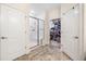 This bathroom features tile flooring, a glass shower door, and closet, all bathed in a neutral, light-filled palette at 306 Cherokee Station Cir, Woodstock, GA 30188