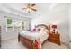 A well lit bedroom with a ceiling fan, a window, and a floral comforter at 306 Cherokee Station Cir, Woodstock, GA 30188