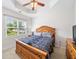 Cozy bedroom with ceiling fan, large windows, and a patterned blue comforter at 306 Cherokee Station Cir, Woodstock, GA 30188