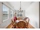 Bright dining room with a chandelier, hardwood floors, and natural light from large windows at 306 Cherokee Station Cir, Woodstock, GA 30188