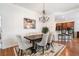 Elegant dining area with chandelier, hardwood floors, and seamless flow to the kitchen at 306 Cherokee Station Cir, Woodstock, GA 30188