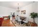 Charming dining area with chandelier, hardwood floors, and easy access to the adjacent living spaces at 306 Cherokee Station Cir, Woodstock, GA 30188