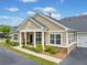 Charming home features a covered front porch, an attached garage, and a neatly landscaped yard with lush greenery at 306 Cherokee Station Cir, Woodstock, GA 30188
