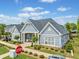 Charming community clubhouse featuring blue siding, lush landscaping, and a convenient handicap parking space at 306 Cherokee Station Cir, Woodstock, GA 30188