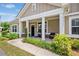 Welcoming front porch with classic columns and seating, enhancing the curb appeal of this charming home at 306 Cherokee Station Cir, Woodstock, GA 30188