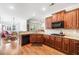 A kitchen featuring brown cabinets, granite countertops, and hardwood flooring at 306 Cherokee Station Cir, Woodstock, GA 30188