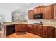 A kitchen featuring brown cabinets, granite countertops, and hardwood flooring at 306 Cherokee Station Cir, Woodstock, GA 30188