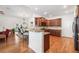 Open concept kitchen with dark wood cabinets, granite counters, and stainless steel appliances at 306 Cherokee Station Cir, Woodstock, GA 30188
