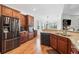 A kitchen with stainless steel refrigerator, brown cabinets, and hardwood flooring at 306 Cherokee Station Cir, Woodstock, GA 30188