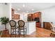 Open kitchen featuring granite countertops, a breakfast bar, and hardwood floors at 306 Cherokee Station Cir, Woodstock, GA 30188