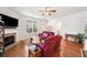 Inviting living room with a fireplace, hardwood floors, and ample natural light creating a warm atmosphere at 306 Cherokee Station Cir, Woodstock, GA 30188