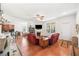 Bright and open living room featuring a fireplace, hardwood floors, and seamless flow to the dining and kitchen areas at 306 Cherokee Station Cir, Woodstock, GA 30188