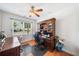 Well-lit home office featuring custom wood built-ins and views of the neighborhood at 306 Cherokee Station Cir, Woodstock, GA 30188
