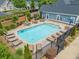 Beautiful community pool surrounded by comfortable lounge chairs, tables, and lush landscaping for relaxation and enjoyment at 306 Cherokee Station Cir, Woodstock, GA 30188