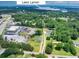 Aerial view showcases the property's location near Lake Lanier with lush greenery and surrounding neighborhood at 3180 Lee Dr, Buford, GA 30518