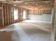 Unfinished basement with concrete flooring, framed walls, and natural light from windows at 3180 Lee Dr, Buford, GA 30518